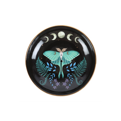 Decorative plate with a butterfly design on a black background