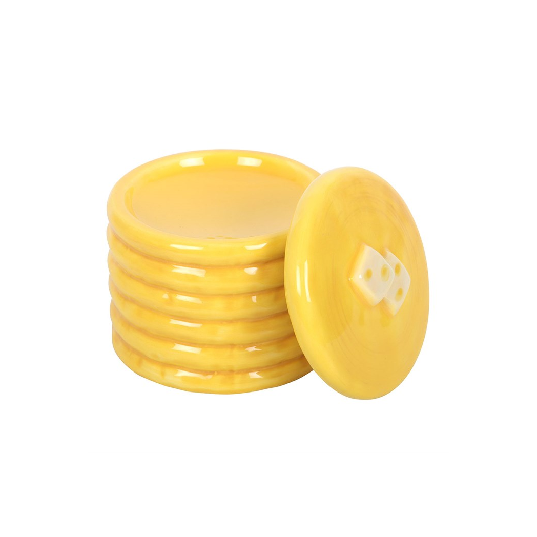 Yellow pancake-stack ceramic oil burner with star cutouts, glossy glaze, and matching lid.