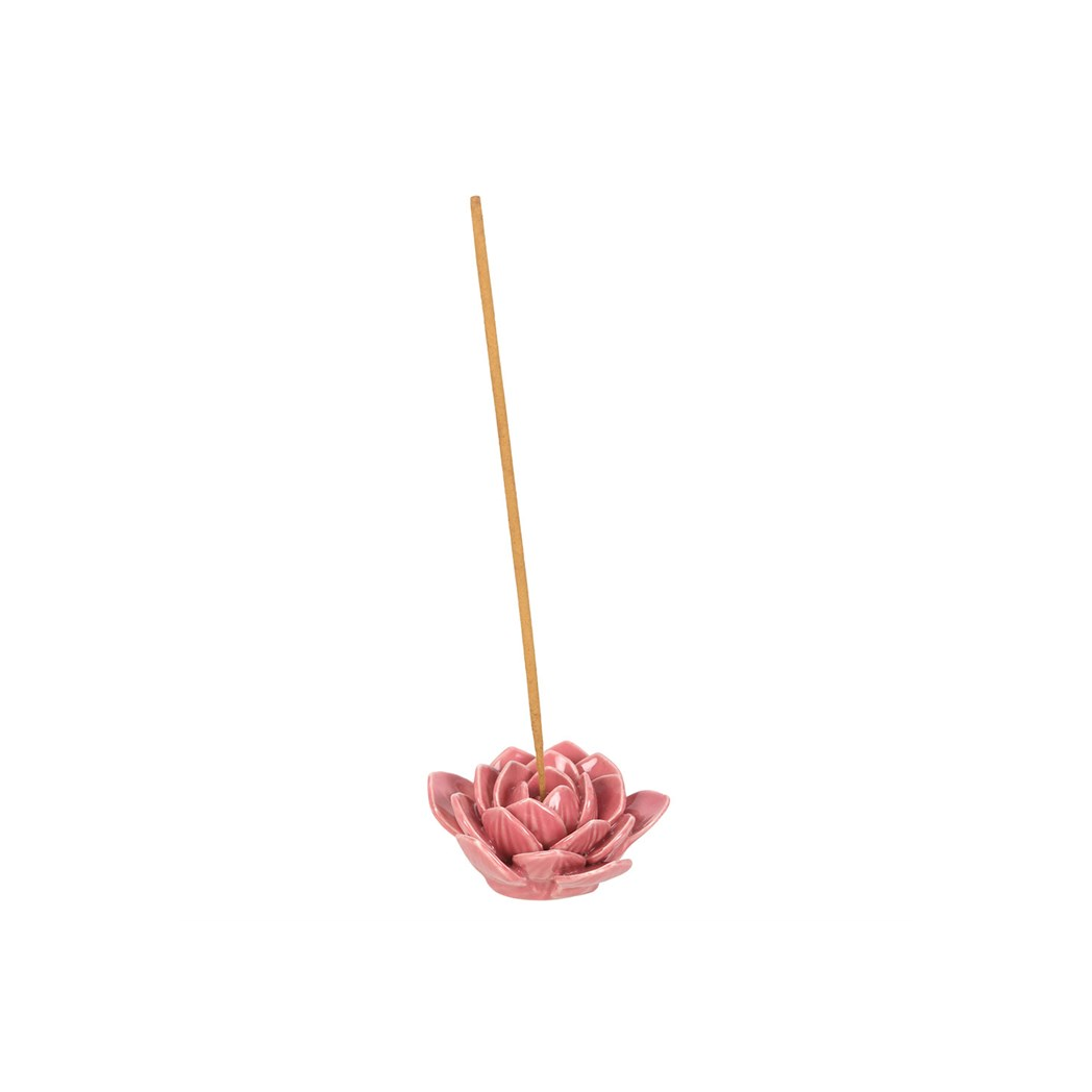 Pink lotus-shaped incense holder with a single incense stick on a white background
