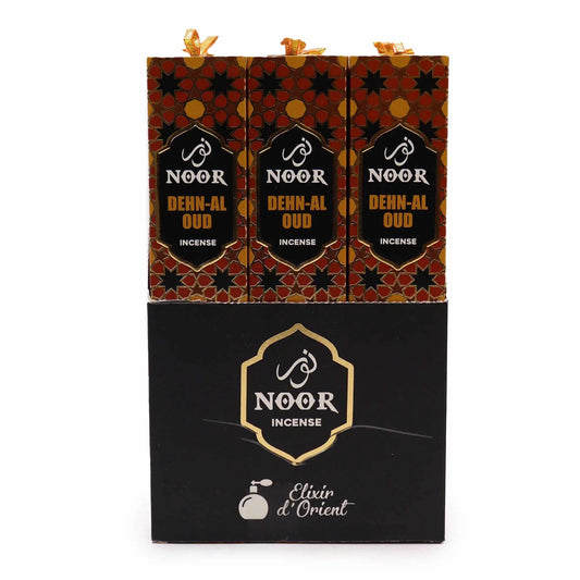 Three Noor Dehn-Al Oud incense gift boxes with red-gold geometric packaging and Noor logo.