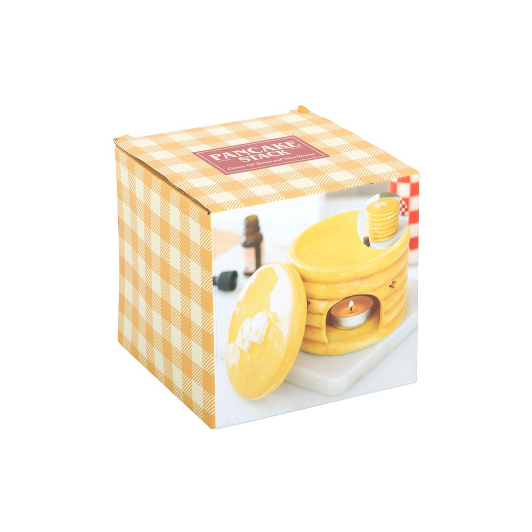 Pancake-stack ceramic oil burner in glossy yellow with star cutouts and syrup finish.